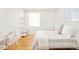 Bright bedroom with white walls, hardwood floors, and a comfortable bed with stylish decor at 3957 Utica St, Denver, CO 80212