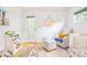 Bright Bedroom featuring a comfortable chair, alphabet rug and curated books at 3957 Utica St, Denver, CO 80212