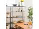 Bright dining area featuring shelving with decorative items and wooden table with seating near a tree at 3957 Utica St, Denver, CO 80212