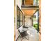 Inviting front porch with stylish seating, a hanging flower basket, and modern architectural details at 3957 Utica St, Denver, CO 80212