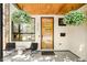 Inviting front porch featuring stylish seating, hanging flower baskets, and a modern front door at 3957 Utica St, Denver, CO 80212