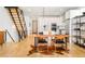 Bright, modern kitchen with stainless steel appliances, wooden table, and adjacent staircase at 3957 Utica St, Denver, CO 80212