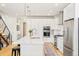Bright kitchen with stainless steel appliances, modern lighting, and spacious island at 3957 Utica St, Denver, CO 80212