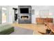 Sunlit living room featuring a fireplace, TV, hardwood floors, and modern furnishings at 3957 Utica St, Denver, CO 80212