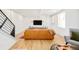 Modern living room featuring hardwood floors, shiplap accent wall and a comfortable seating arrangement at 3957 Utica St, Denver, CO 80212