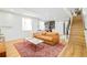 Open-concept living area with stylish sofa, area rug and staircase leading to the upper level at 3957 Utica St, Denver, CO 80212