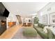 Open living space features a fireplace, modern decor, wood floors, and a staircase at 3957 Utica St, Denver, CO 80212