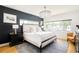 Main bedroom with a chandelier, hardwood floors, modern furniture, and ample natural light at 3957 Utica St, Denver, CO 80212