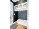 Mud room with storage cubbies, coat hooks, seating, and a patterned welcome mat at 3957 Utica St, Denver, CO 80212