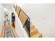 Staircase featuring hardwood steps, a modern railing and a runner leading to the second level at 3957 Utica St, Denver, CO 80212