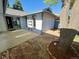 A private backyard featuring a patio, mature tree, and rock landscaping at 53 Douglas S Dr, Broomfield, CO 80020