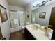 A traditional bathroom with a shower/tub combo and a vanity with a white countertop at 53 Douglas S Dr, Broomfield, CO 80020
