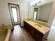 Bathroom featuring a soaking tub and a double vanity sink at 53 Douglas S Dr, Broomfield, CO 80020