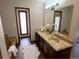 A luxurious bathroom featuring a double sink vanity, soaking tub, and wood-look flooring at 53 Douglas S Dr, Broomfield, CO 80020