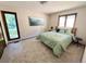 A bright bedroom with a green quilt, two windows, and dark trim at 53 Douglas S Dr, Broomfield, CO 80020