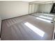 Spacious bedroom with mirrored closet doors and neutral-colored carpet at 53 Douglas S Dr, Broomfield, CO 80020