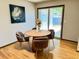 Cozy dining nook with a wooden round table, soft chairs, and a view of the outdoors at 53 Douglas S Dr, Broomfield, CO 80020