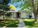 Charming single-story home with a well-manicured lawn and beautiful landscaping, framed by mature trees at 53 Douglas S Dr, Broomfield, CO 80020
