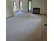 Spacious living room with a fireplace and carpeted floors, bathed in natural light from large windows at 53 Douglas S Dr, Broomfield, CO 80020