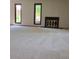 Bright living room with a carpeted floor, a dark fireplace, and large windows providing natural light at 53 Douglas S Dr, Broomfield, CO 80020