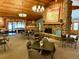 Spacious lodge featuring wood ceilings, a stone fireplace, and tables for dining and relaxation at 53 Douglas S Dr, Broomfield, CO 80020