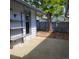 A small patio space, enclosed with a fence and mature tree to provide privacy and shade at 53 Douglas S Dr, Broomfield, CO 80020