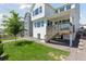Beautiful backyard featuring a well-maintained lawn, a patio, and exterior stairs at 13326 Blue Amber Ct, Parker, CO 80134
