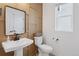 Elegant powder room with a pedestal sink, modern fixtures, and neutral color palette at 13326 Blue Amber Ct, Parker, CO 80134