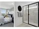 This bathroom features a glass enclosed shower and opens into the main bedroom at 13326 Blue Amber Ct, Parker, CO 80134