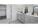Stylish bathroom features double sinks with gray cabinetry and a large mirror at 13326 Blue Amber Ct, Parker, CO 80134