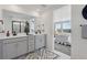 Well-lit bathroom showcasing double sink vanity and view into bedroom at 13326 Blue Amber Ct, Parker, CO 80134