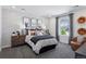 Cozy bedroom with modern furniture, neutral accents, and large sunny window at 13326 Blue Amber Ct, Parker, CO 80134