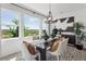 Bright dining room with large windows offering scenic views, a modern chandelier, and stylish decor at 13326 Blue Amber Ct, Parker, CO 80134