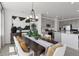 Open-concept dining room features a modern table, stylish decor, and access to the kitchen at 13326 Blue Amber Ct, Parker, CO 80134