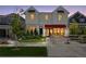 Charming two-story home with a red awning, beautiful landscaping, and a welcoming front entrance at 13326 Blue Amber Ct, Parker, CO 80134