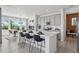 Open kitchen with a large island, modern appliances, and a view to the dining area at 13326 Blue Amber Ct, Parker, CO 80134