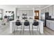 Kitchen featuring stainless steel appliances, a large island with seating, and sleek grey cabinets at 13326 Blue Amber Ct, Parker, CO 80134