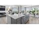 Kitchen featuring stainless steel appliances, a large island with seating, and views to the living room at 13326 Blue Amber Ct, Parker, CO 80134