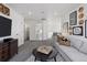 Living room showcases modern decor, gray seating, a dark media center and stylish lighting at 13326 Blue Amber Ct, Parker, CO 80134