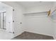 A walk-in closet with neutral carpet, white walls, and a door to bathroom at 13326 Blue Amber Ct, Parker, CO 80134