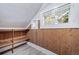 Bright attic space with built-in shelving and wood paneling at 2203 Bellaire St, Denver, CO 80207