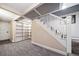 Basement stairs with built-in shelving and carpeted flooring at 2203 Bellaire St, Denver, CO 80207