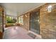 Inviting front porch with a brick floor and ornate door at 2203 Bellaire St, Denver, CO 80207