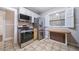 Updated kitchen with stainless steel appliances and light wood cabinets at 2203 Bellaire St, Denver, CO 80207