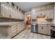 Galley kitchen with light wood cabinets and stainless steel appliances at 2203 Bellaire St, Denver, CO 80207