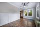 Living room features hardwood floors, wainscoting, and ceiling fan at 2203 Bellaire St, Denver, CO 80207