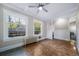 Living room with hardwood floors, built-in shelving, and ceiling fan at 2203 Bellaire St, Denver, CO 80207