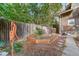 Landscaped side yard with old water pump and garden at 2203 Bellaire St, Denver, CO 80207