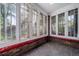 Sunroom with brick floor and multiple windows offering natural light at 2203 Bellaire St, Denver, CO 80207