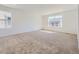 Spacious bedroom with soft carpet, large windows that offer abundant natural light, and neutral-toned walls at 718 N Clubview St, Watkins, CO 80137
